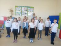 Dzieci śpiewają hymn narodowy.