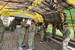 Uczniowie zakładają mundurki do paintballa.