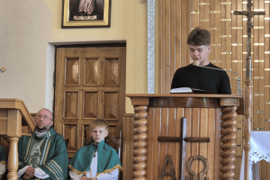 Uczeń klasy ósmej czyta czytanie podczas mszy świętej.