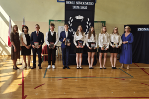 Wyróżnieni uczniowie klasy ósmej z wychowawcą, panią dyrektor i panią wójt.