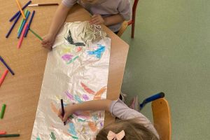 Dziewczynki kolorują rysunek.