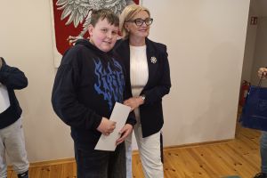 Uczeń klasy siódmej podczas wręczania dyplomu z Wójt Gminy Borowie.